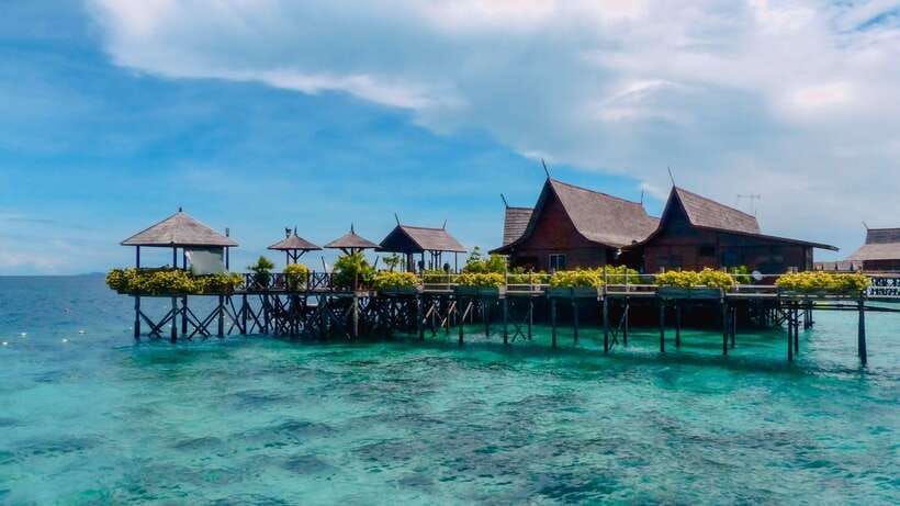 Semporna: Mabul and Kapalai Trip in Snorkel or Dive & Lunch - Mabul Water Bungalows and resort coastline time, photo stop plus real water-life vibes